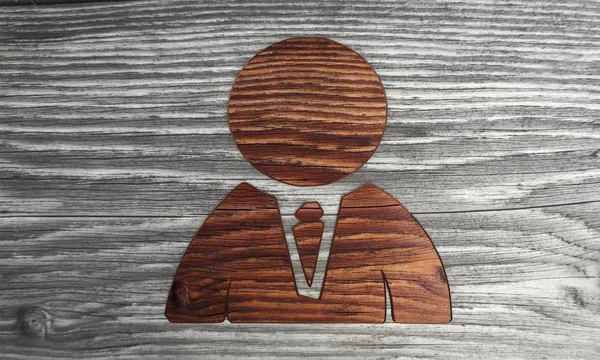 Ecological business man symbol in a wooden background