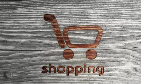 Símbolo de compras em um novo fundo de madeira — Fotografia de Stock
