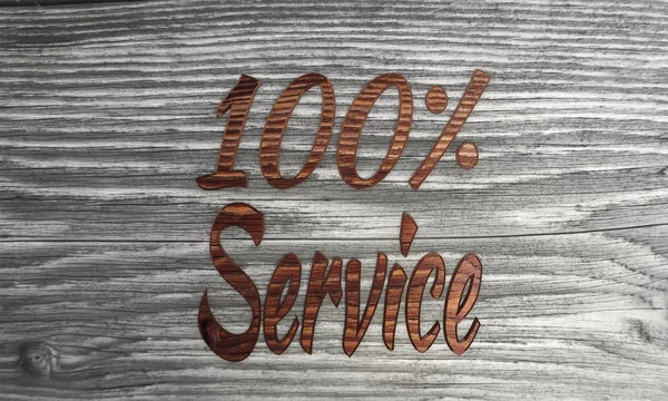 100 percent service symbol on a wooden background — Stock Photo, Image