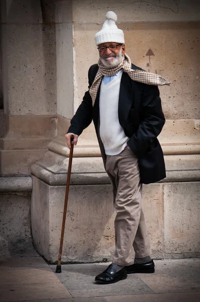 Old man with a funny hat and a walking stick — Stock Photo, Image