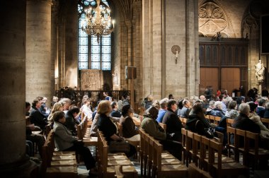 Believers during Mass at Notre Dame Cathedral, Paris, France clipart