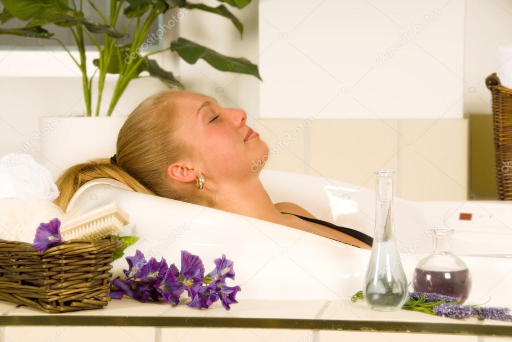 Blond woman in a spa bath relaxing