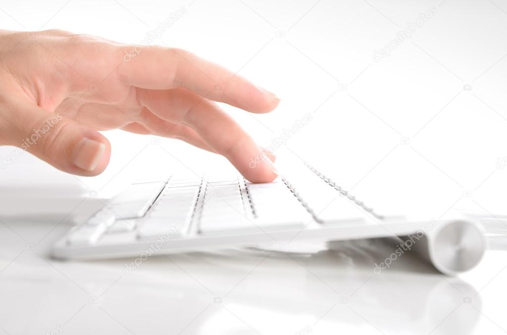Woman's hand typing on computer keyboard