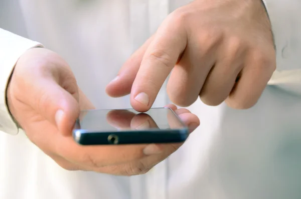 Fechar de um homem usando telefone inteligente móvel — Fotografia de Stock