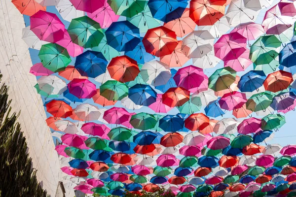 Colored umbrellas hanging at top in a sunny day in Oaxaca, Mexico. Colored umbrellas decoration