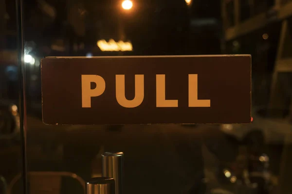 Pull sign board on a glass door