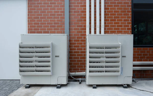 Air compressor or condenser unit installed outside building. Outdoor split air conditioner of the office