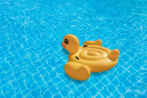 Duck shaped inflatable ring on swinming pool. Concept for summer day