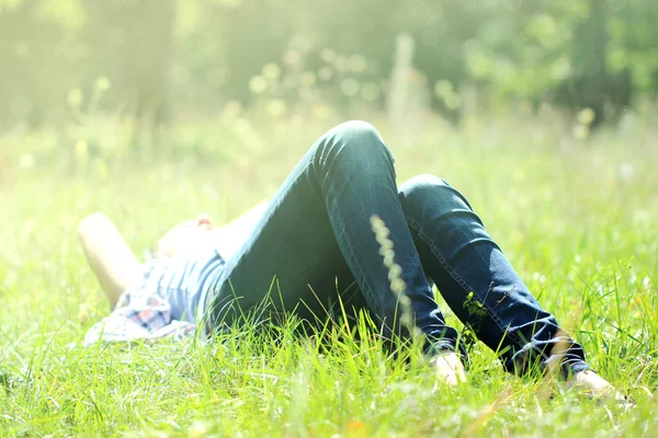 A girl lies on a grass — Stock Photo, Image