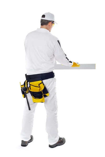 Construction worker in white coveralls smooth wall level nive — Stock Photo, Image