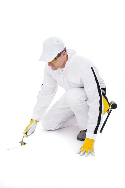 Construction worker in white coveralls trowel tools — Stock Photo, Image