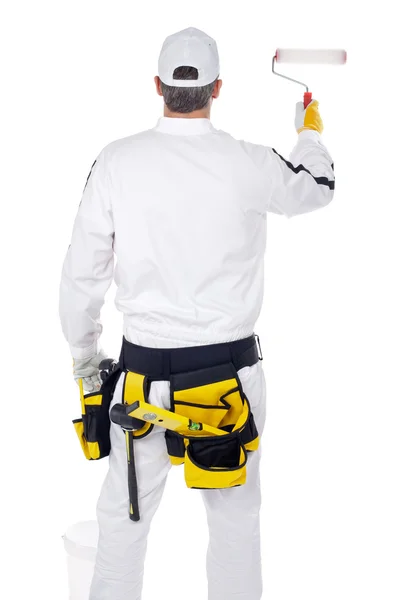 Construction worker in white overalls with paint roller paint — Stock Photo, Image