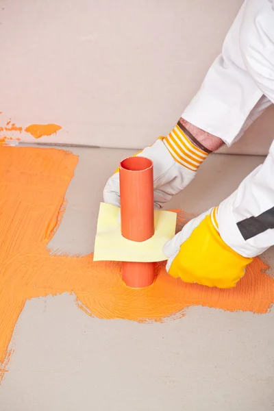 Plumber builder brush applied waterproofing on the floor of the — Stock Photo, Image