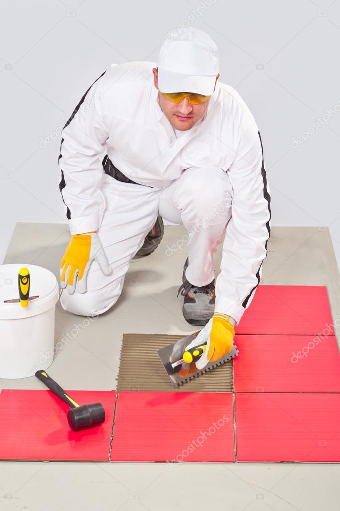 Appling Tile Adhesive with Notched Trowel on a Floor