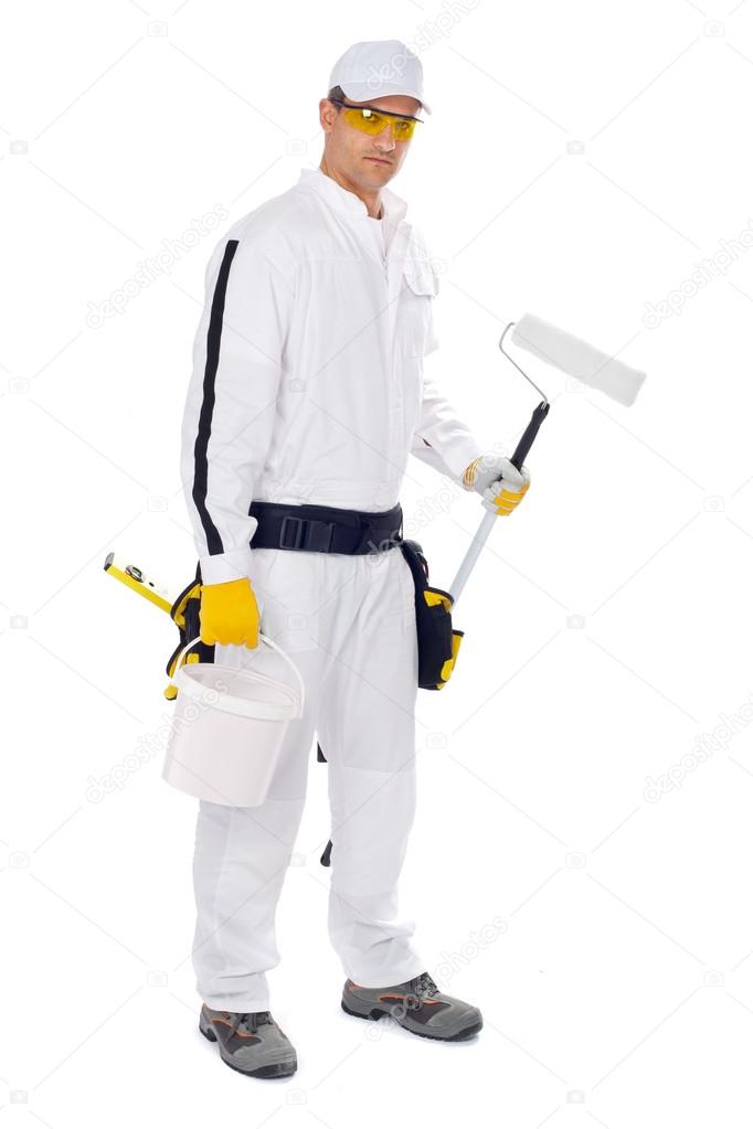 Painter in white overalls holding paint brush bucket