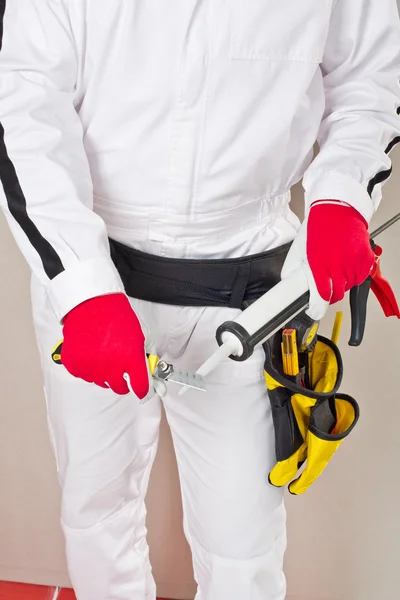 Worker cuts cap sealant silicon — Stock Photo, Image