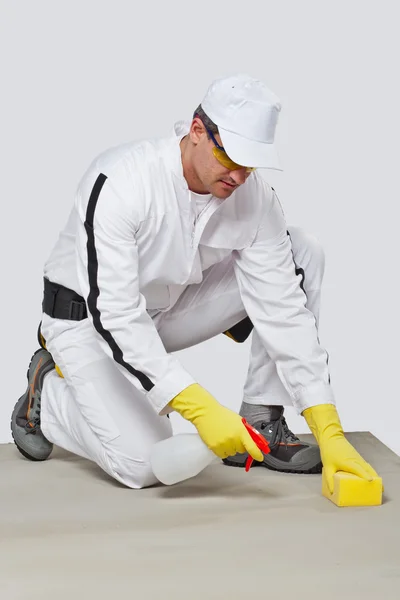 Worker sponge clean cement substrate — Stock Photo, Image
