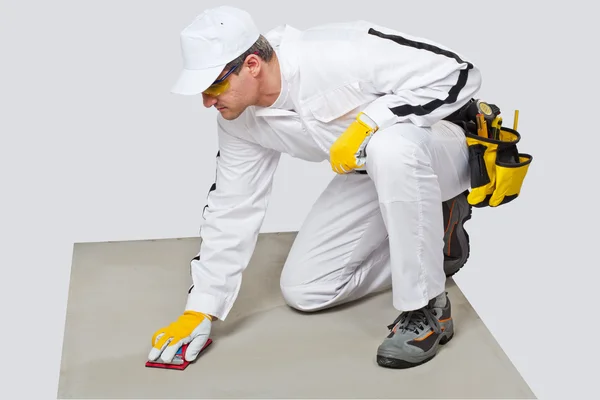 Worker sand paper clean cement substrate — Stock Photo, Image