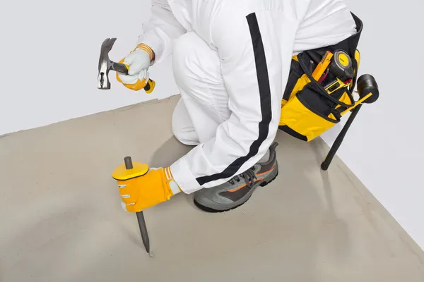 Worker with chisel check concrete base — Stock Photo, Image