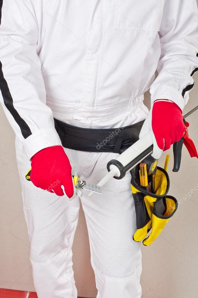 Worker cuts cap sealant silicon