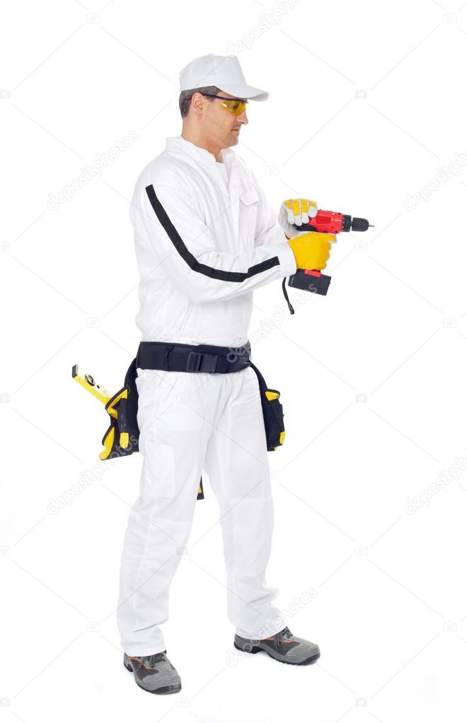 Worker in white overalls with a red drill hole drilling