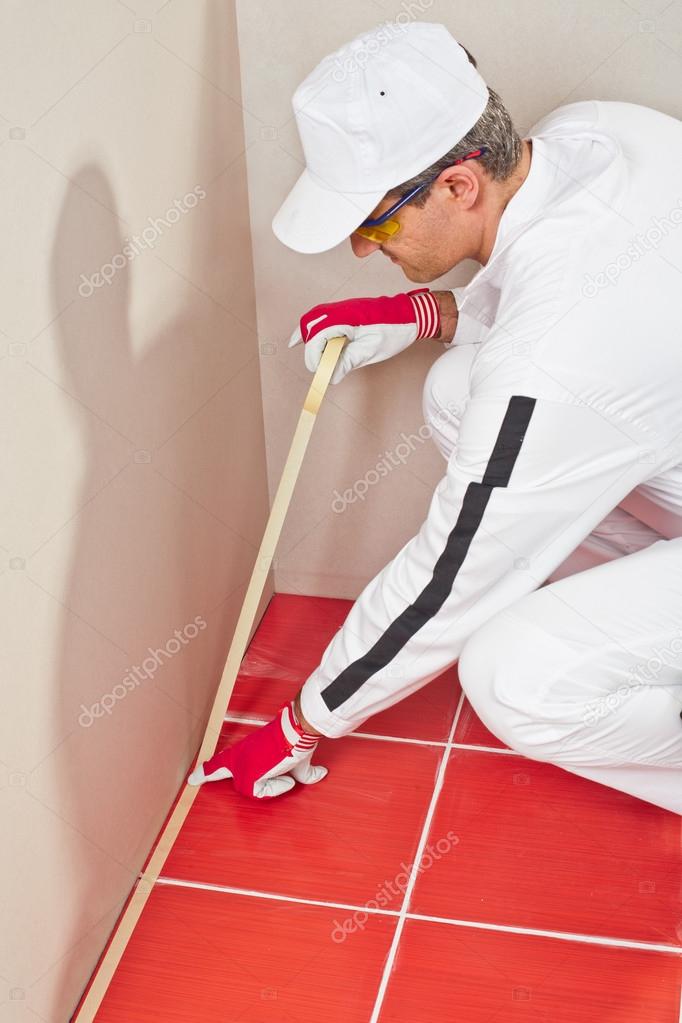 Worker wrapped with masking tape red tiles