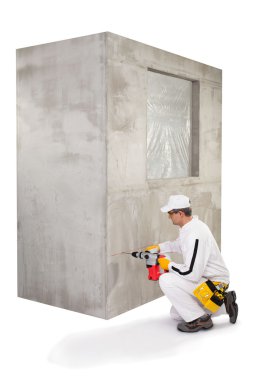 Worker making a hole with a perforator