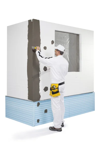 Worker coating a corner-lath with a putty — Stock Photo, Image