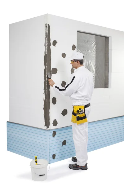 Worker coating a corner-lath with a putty — Stock Photo, Image