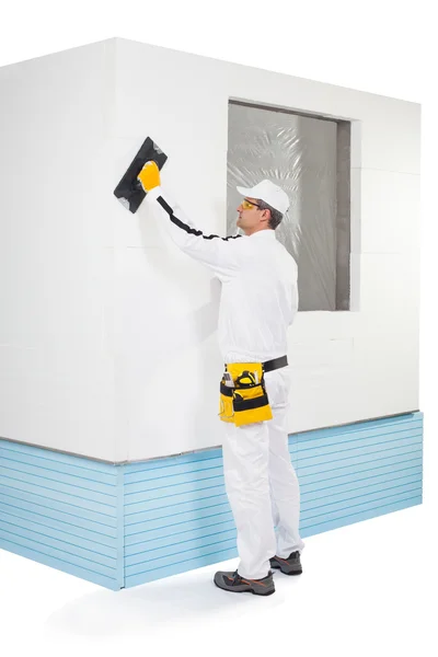 Worker rasping insulation panels — Stock Photo, Image