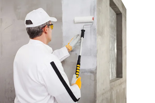 Worker priming with a paint roller — Stock Photo, Image