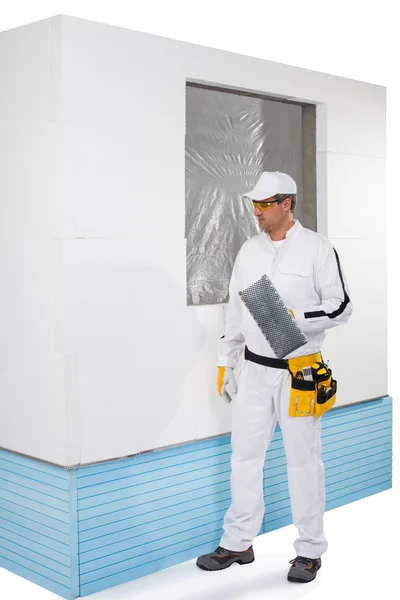 Worker holding a finishing insulation rasp — Stock Photo, Image