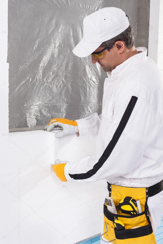 Worker fixing an insulation panel