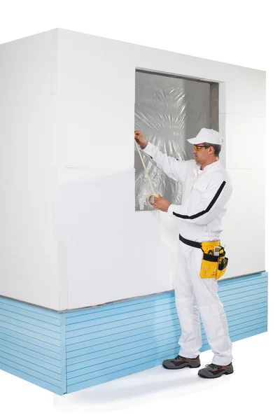 Worker taping a frame of window with a masking tape — Stock Photo, Image