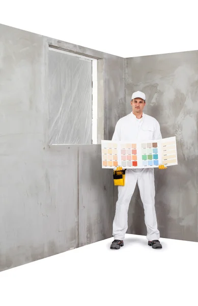 Trabalhador segurando uma paleta de amostras de cores — Fotografia de Stock