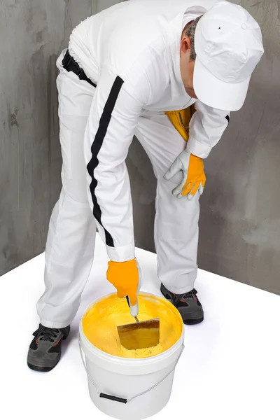 Worker mixing a plaster with a trowel — Stock Photo, Image