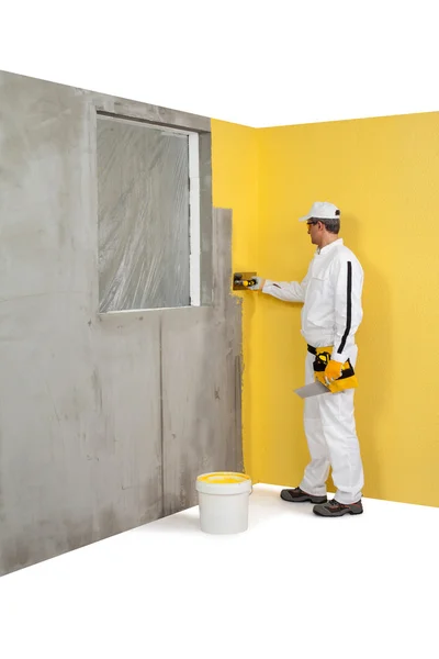 Worker spreading a plaster on a corner-wall — Stock Photo, Image