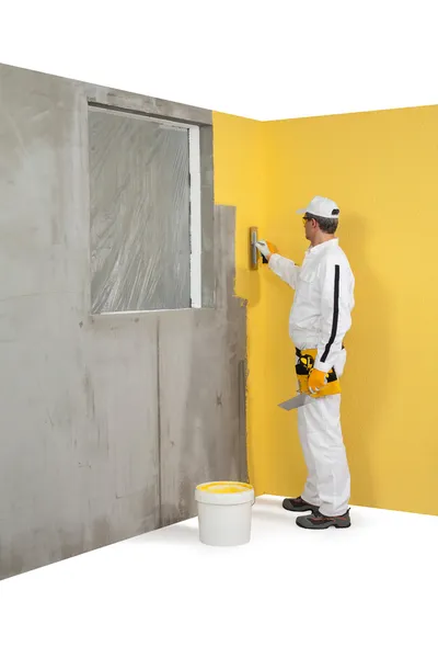 Worker spreading a plaster on a corner-wall — Stock Image Worker spreading a plaster on a corner-wall Royalty Free Stock Photos