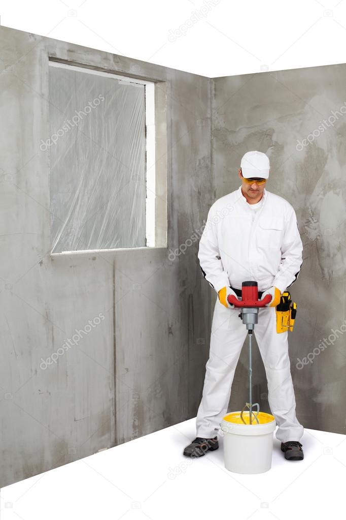 Worker mixing a plaster with a stirrer machine