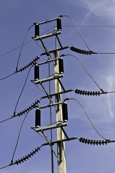 High voltage post against blue sky — Stock Photo, Image