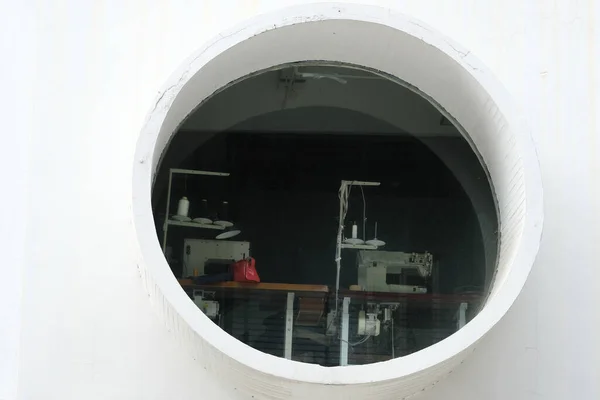 circle window and machine in the building