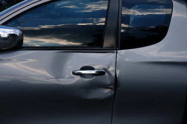 dents on the car body and car door handle