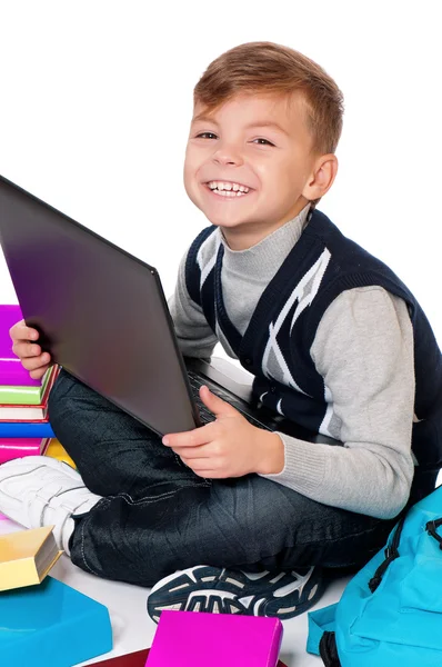 Menino com laptop e livros — Fotografia de Stock