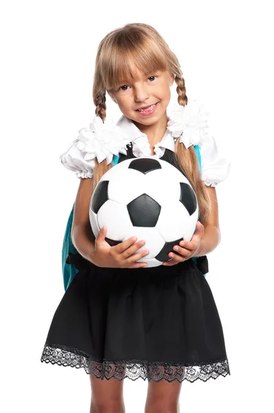 Маленька школярка з футбольним м'ячем — стокове фото