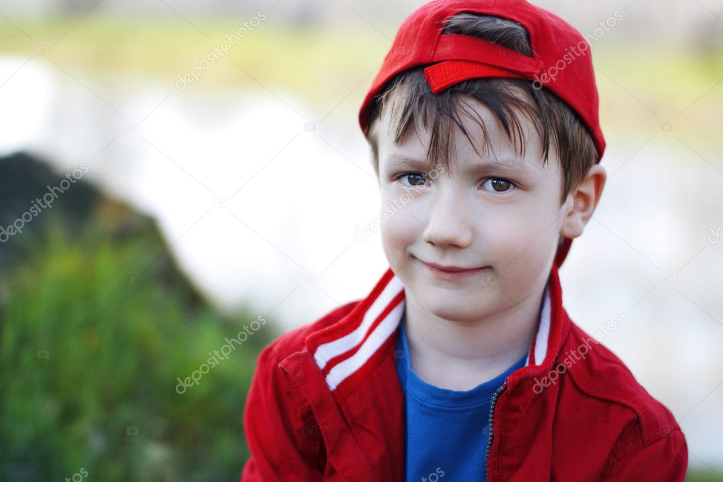 Cute child in red cap at outdoor