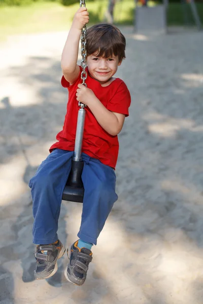 Kid sit on swing rope — Stock Photo, Image