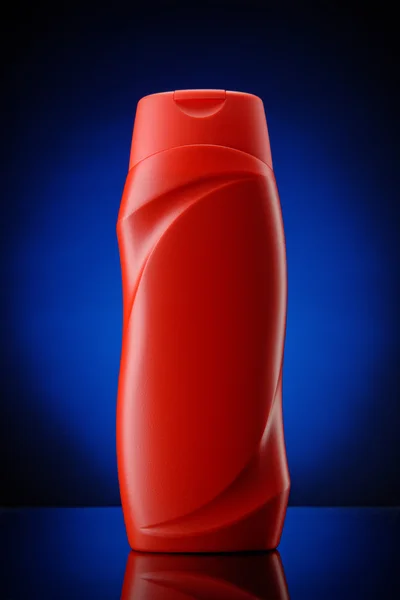 Contenitore shampoo di plastica rosso — Foto Stock