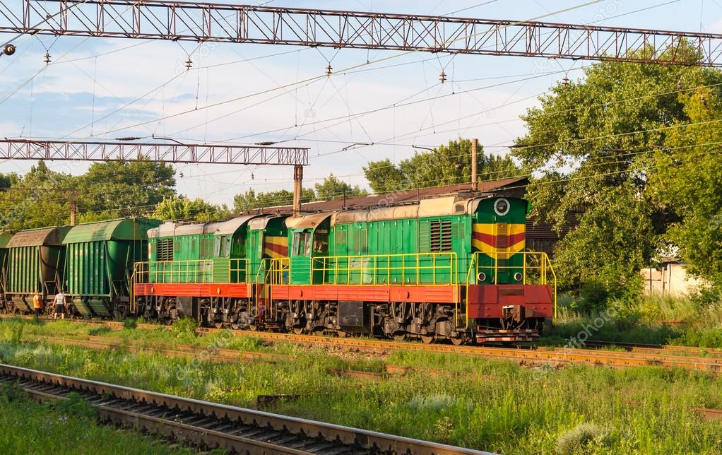 Two shunters with freight train at a station