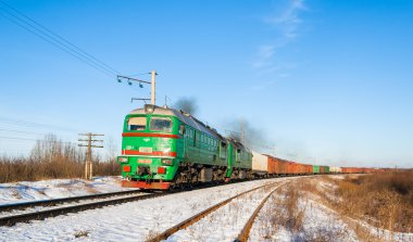 Freight train hauled by diesel locomotive. Ukrainian railways clipart