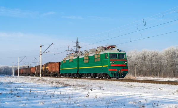 Freight train hauled by electric locomotive — Stock Photo, Image